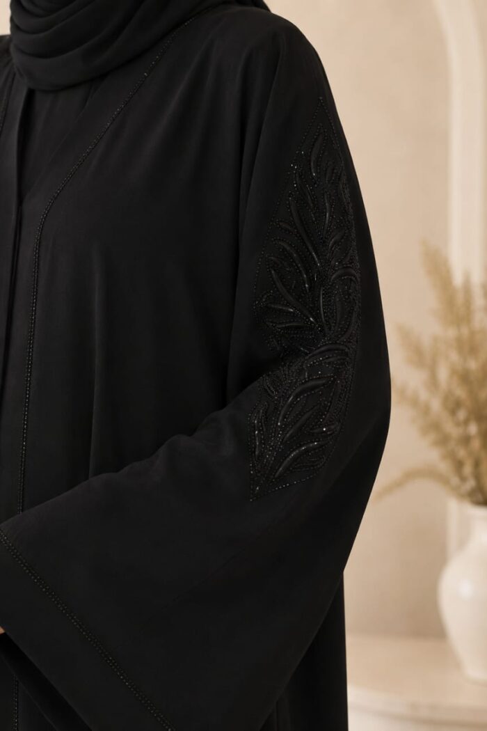 Black stone nag abaya close-up of stone motif embroidery on sleeve