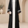 Green Qatari broshia velvet abaya front view worn open over white inner dress