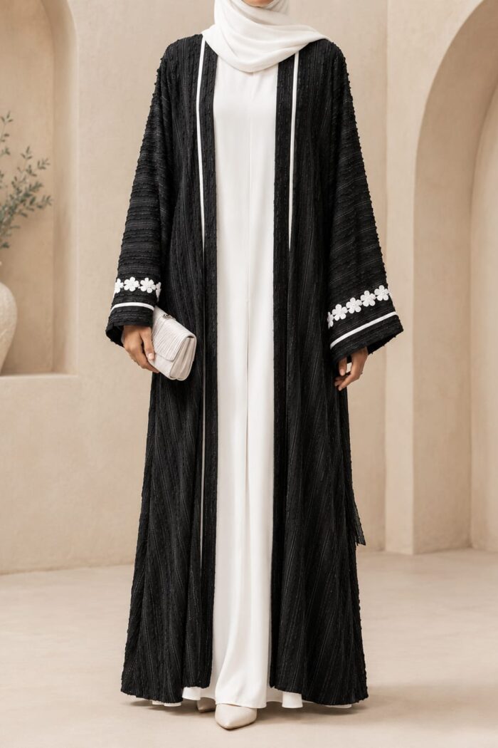 Green Qatari broshia velvet abaya front view worn open over white inner dress