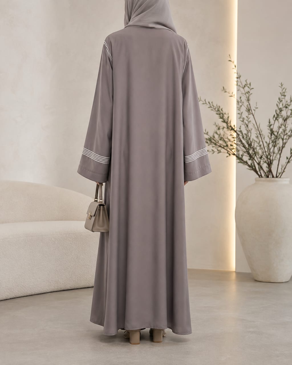 Light grey dori embroidered tasal gown with striped cuffs - back view