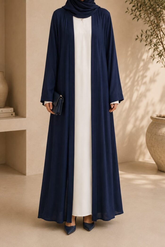 Mazdoja lining tench abaya in navy blue open coat over white dress - front view