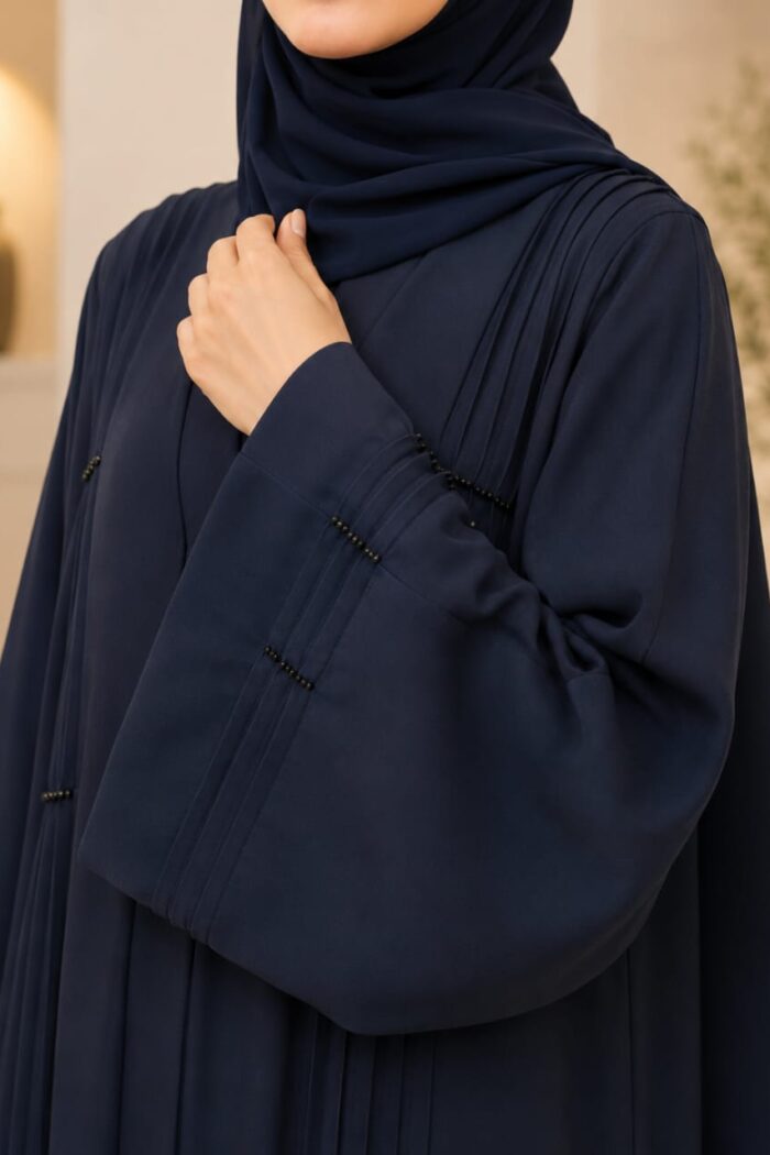 Navy blue stone abaya close-up of pleated plates and bead stone detail on cuff