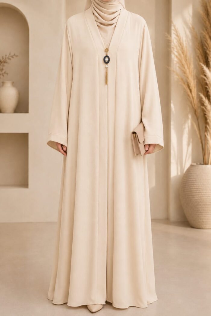 Off-white medallion abaya front view with medallion pendant detail