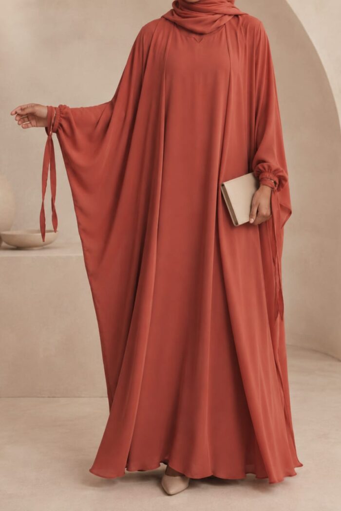 Rust orange kaftan abaya front view with ribbon cuff tie detail