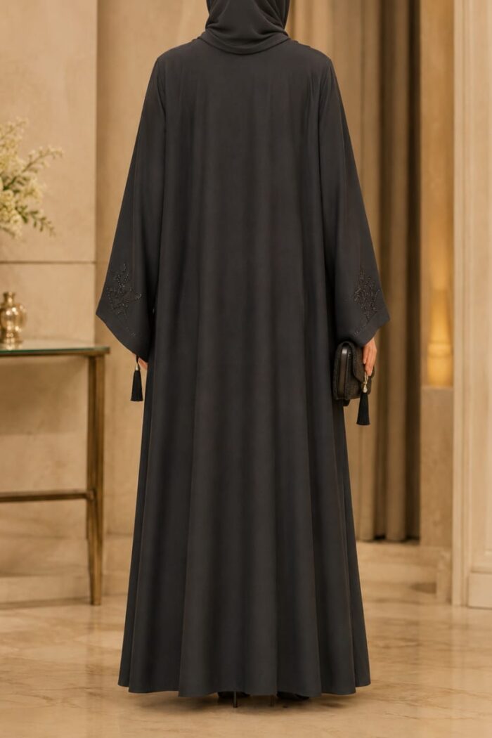 Zoom Arabian Katdana Abaya in black, back view showing flowing silhouette and cuff tassel detail