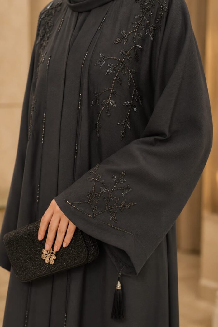 Zoom Arabian Katdana Abaya in black, close-up of katdana beaded embroidery and tassel on cuff