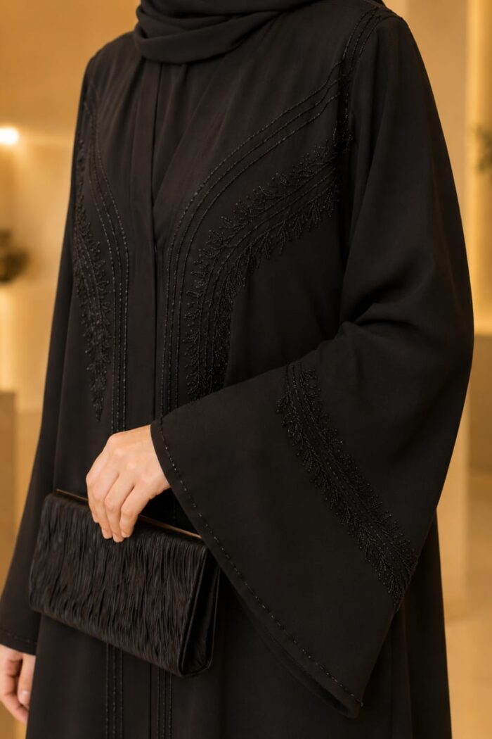 Zoom Zari Abaya in black, close-up of stone work embroidery on umbrella sleeve and cuff