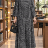Falcon maxi abaya in black and white Spick Dot design, front view, with decorative texture on the front and shoulders