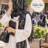 Kalam Kar Stoler in Black draped as a hijab